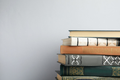 Photo of Collection of old books on light background, space for text