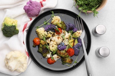 Photo of Delicious salad with cauliflower and tomato served on white table, flat lay