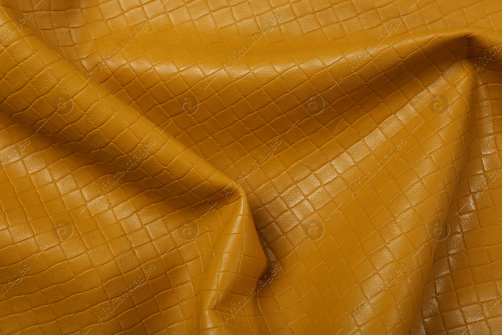 Photo of Beautiful yellow leather as background, top view