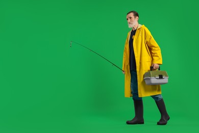 Fisherman with rod and tackle box on green background, space for text