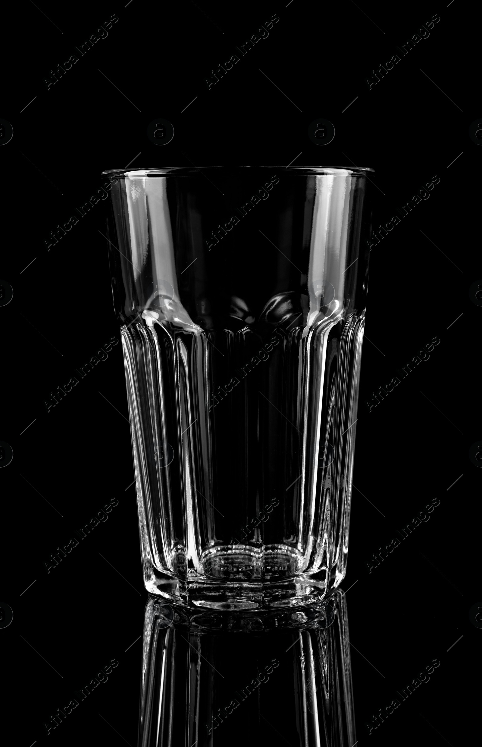 Photo of New clean empty glass on black background