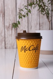 Photo of MYKOLAIV, UKRAINE - AUGUST 12, 2021: Hot McDonald's drink on white wooden table