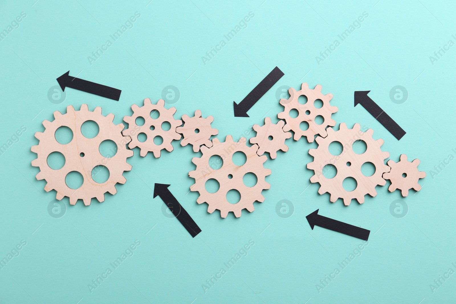 Photo of Business process organization and optimization. Scheme with wooden figures and arrows on light blue background, top view