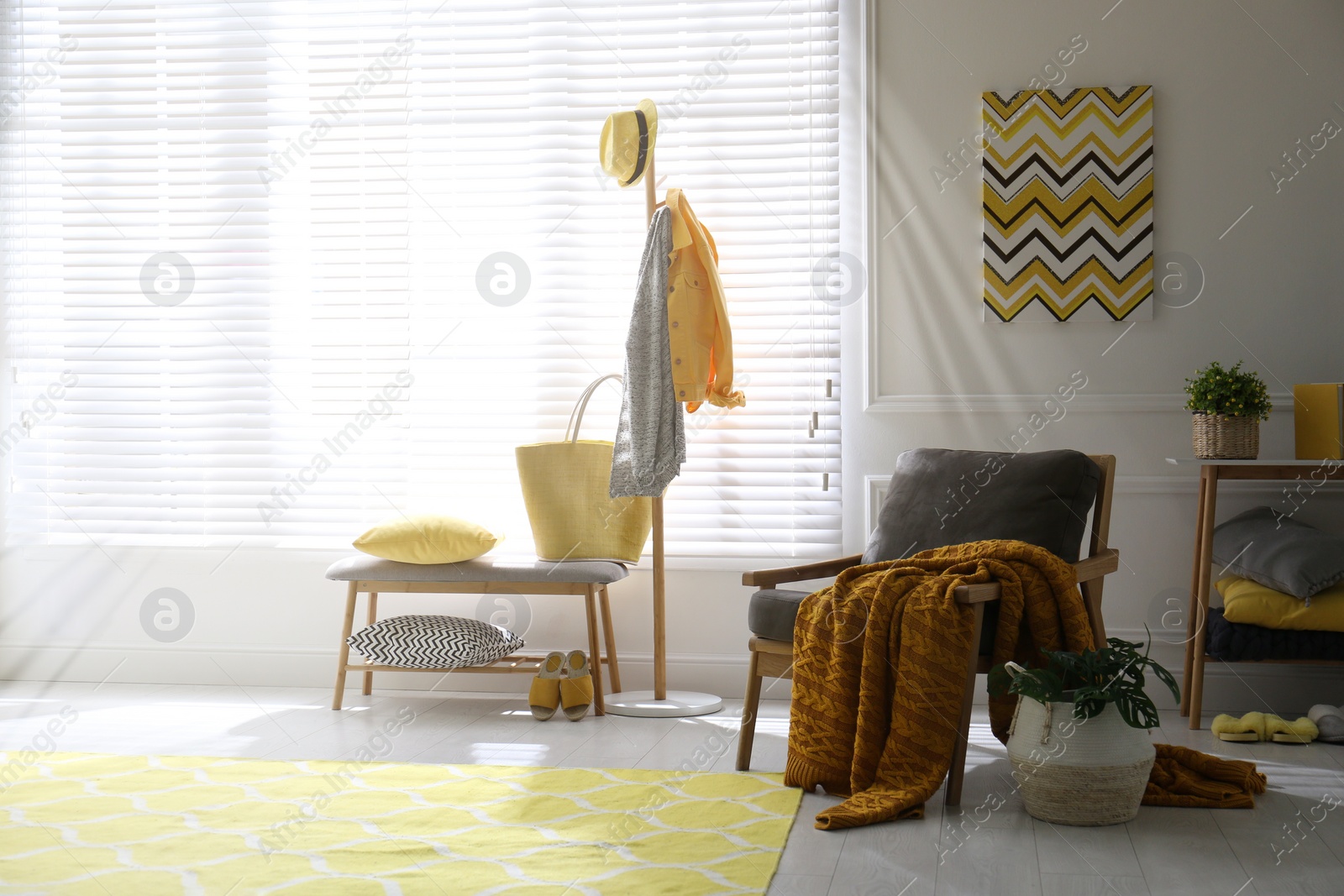 Photo of Comfortable armchair with plaid in living room. Interior design