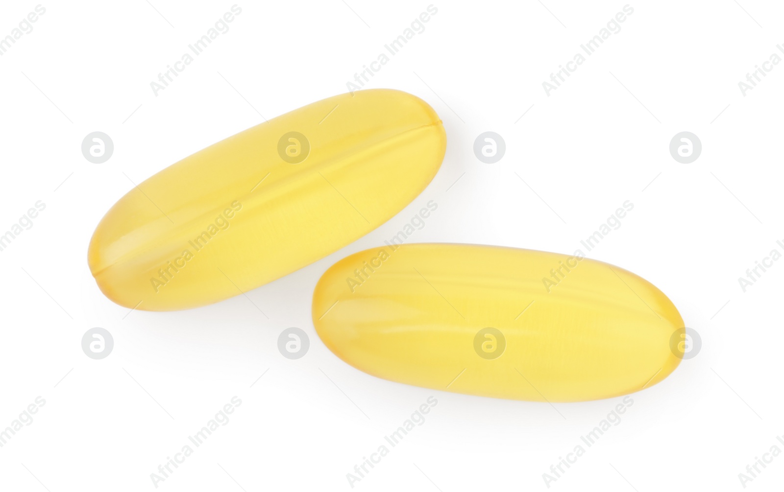 Photo of Yellow vitamin capsules isolated on white, top view