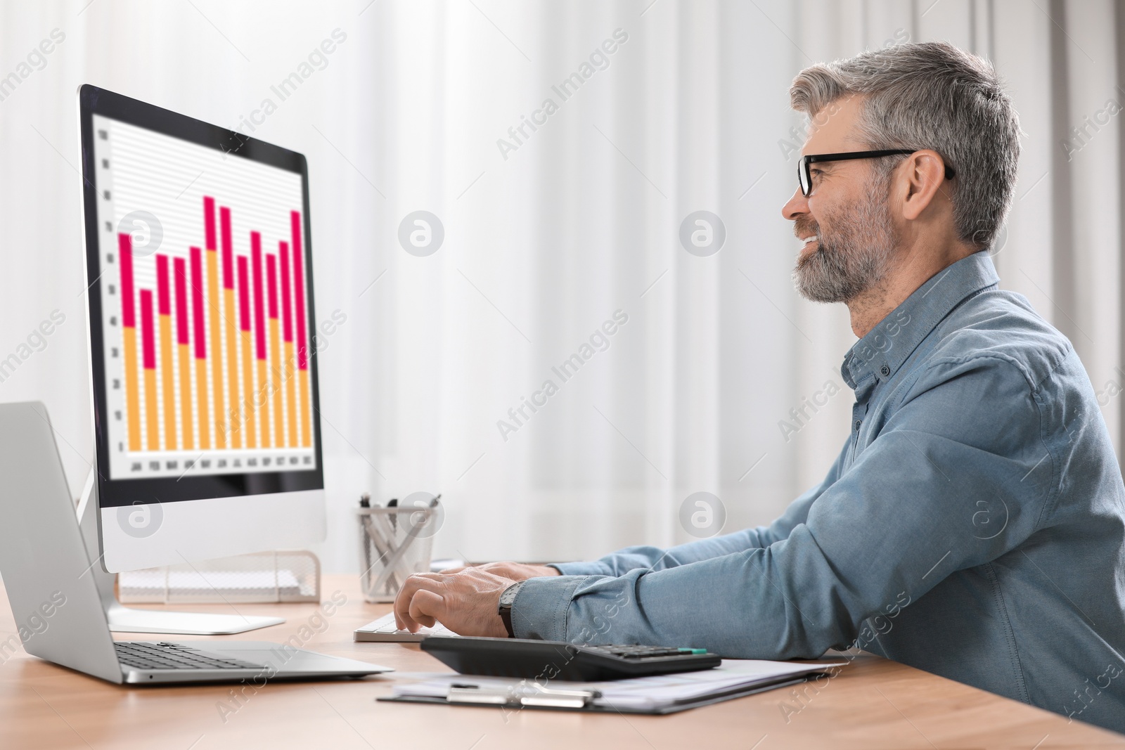 Photo of Professional accountant working on computer at wooden desk in office