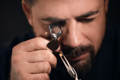 Photo of Professional jeweler working with gemstone, closeup view