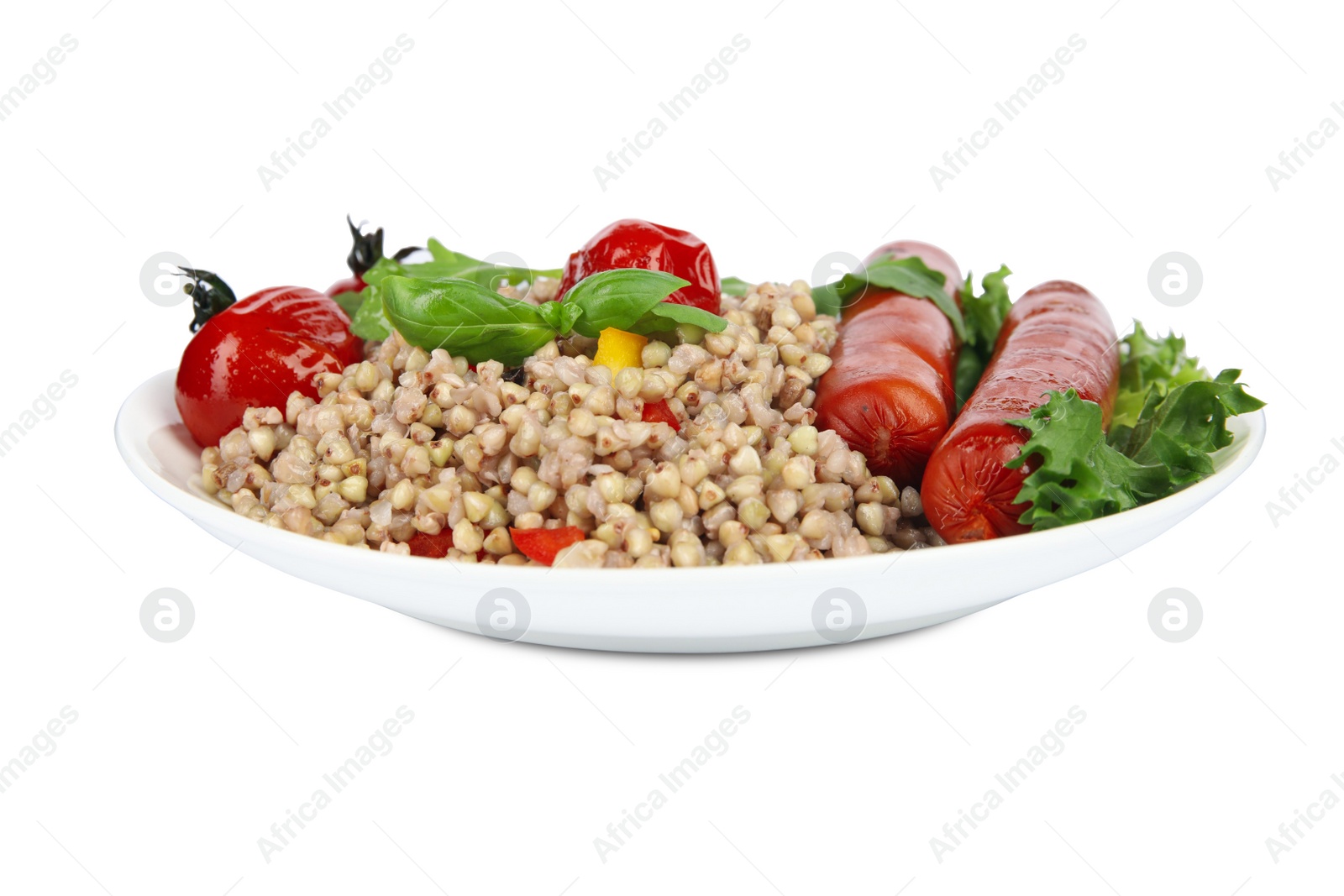 Photo of Tasty buckwheat porridge with sausages and vegetables isolated on white