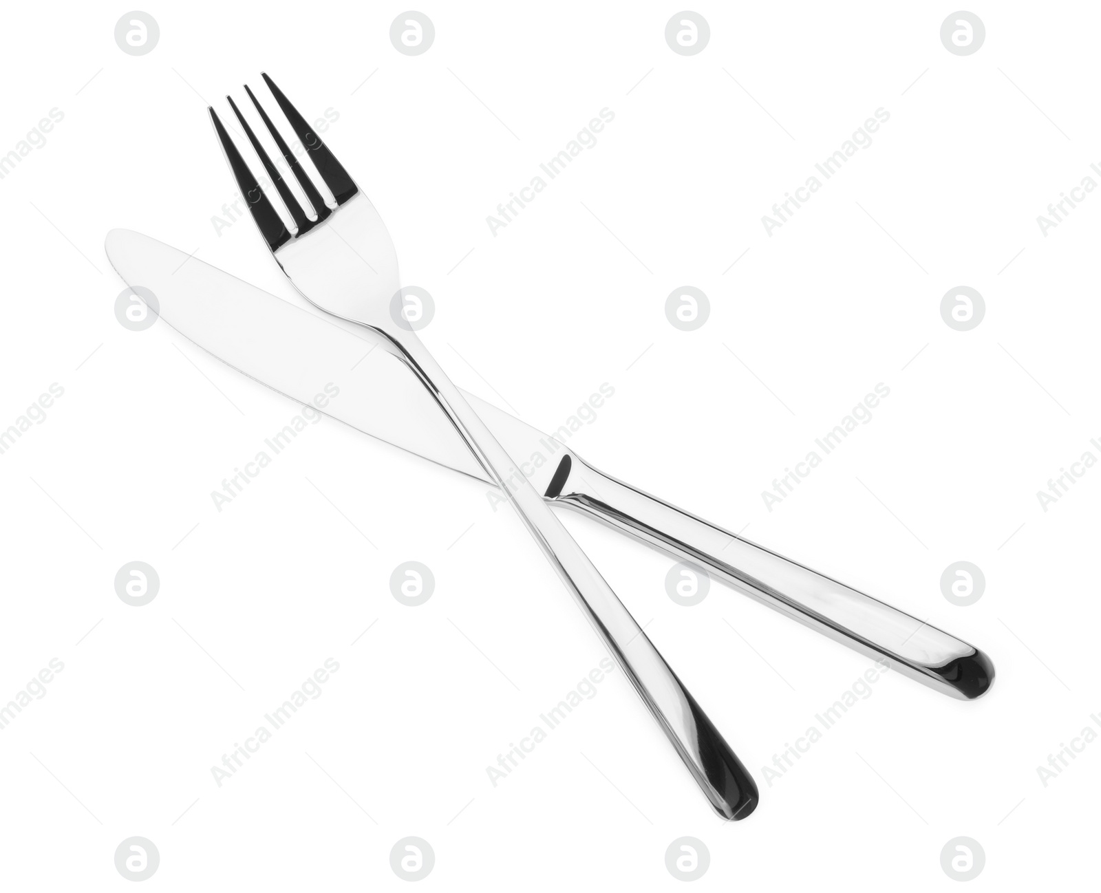 Photo of Shiny silver fork and knife isolated on white. Luxury cutlery