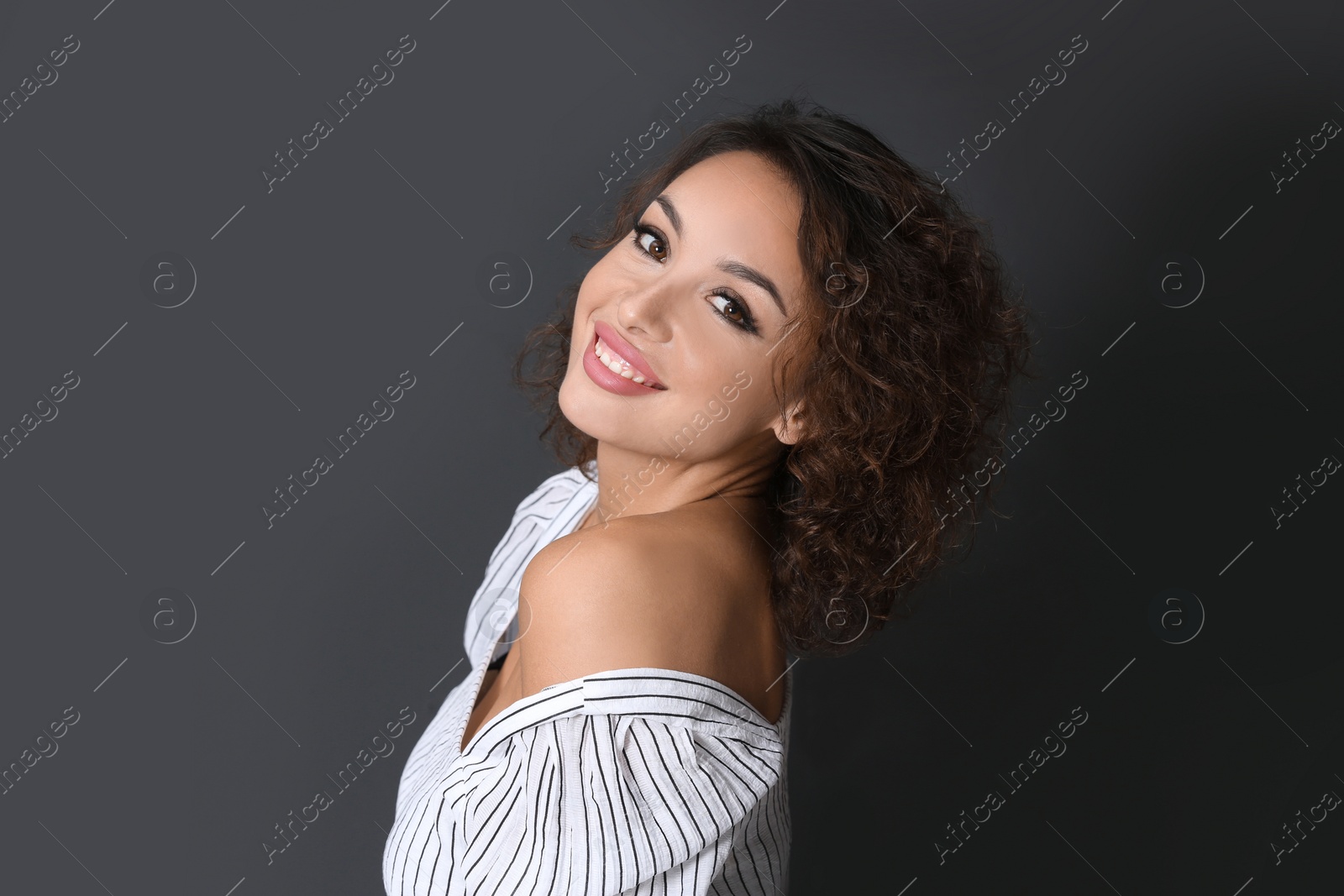 Photo of Beautiful woman in casual outfit on black background