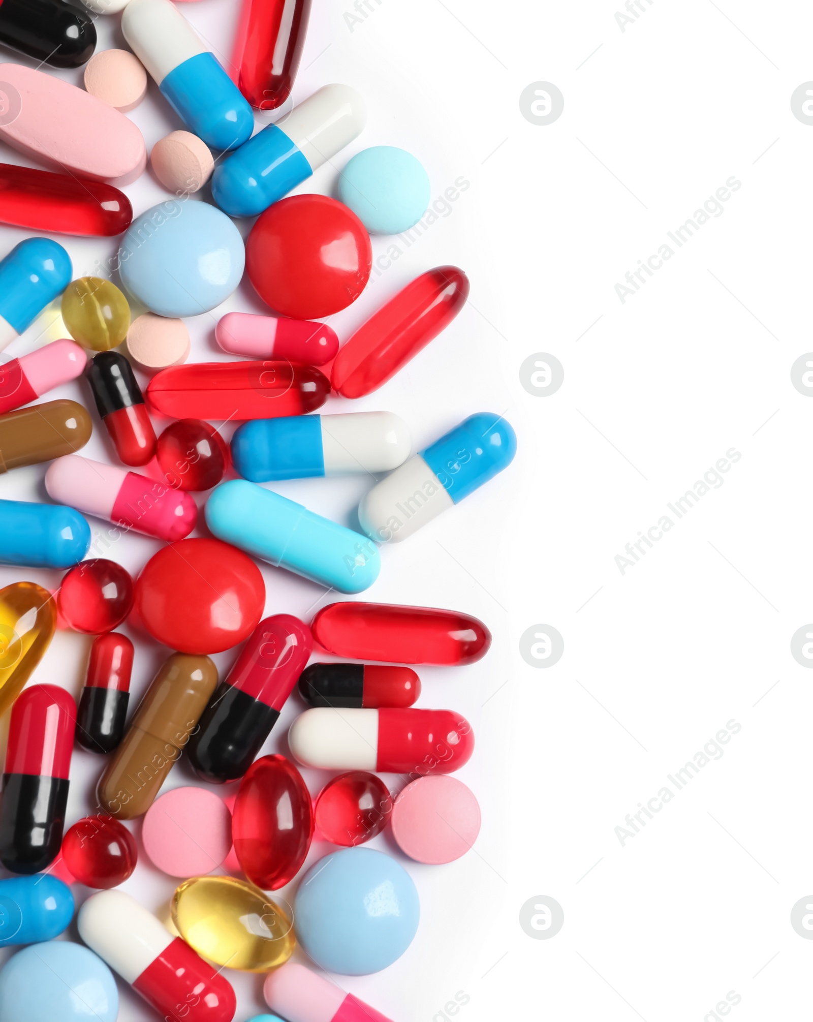 Photo of Lots of different colorful pills isolated on white, top view