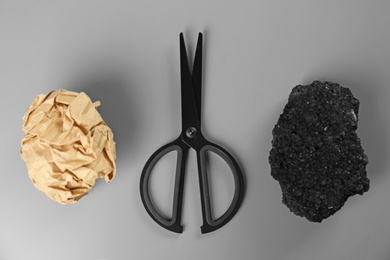 Flat lay composition with rock, paper and scissors on grey background