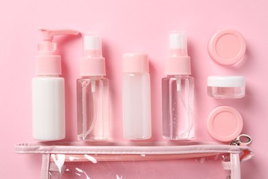 Photo of Plastic bag with cosmetic travel kit on pink background, flat lay. Bath accessories