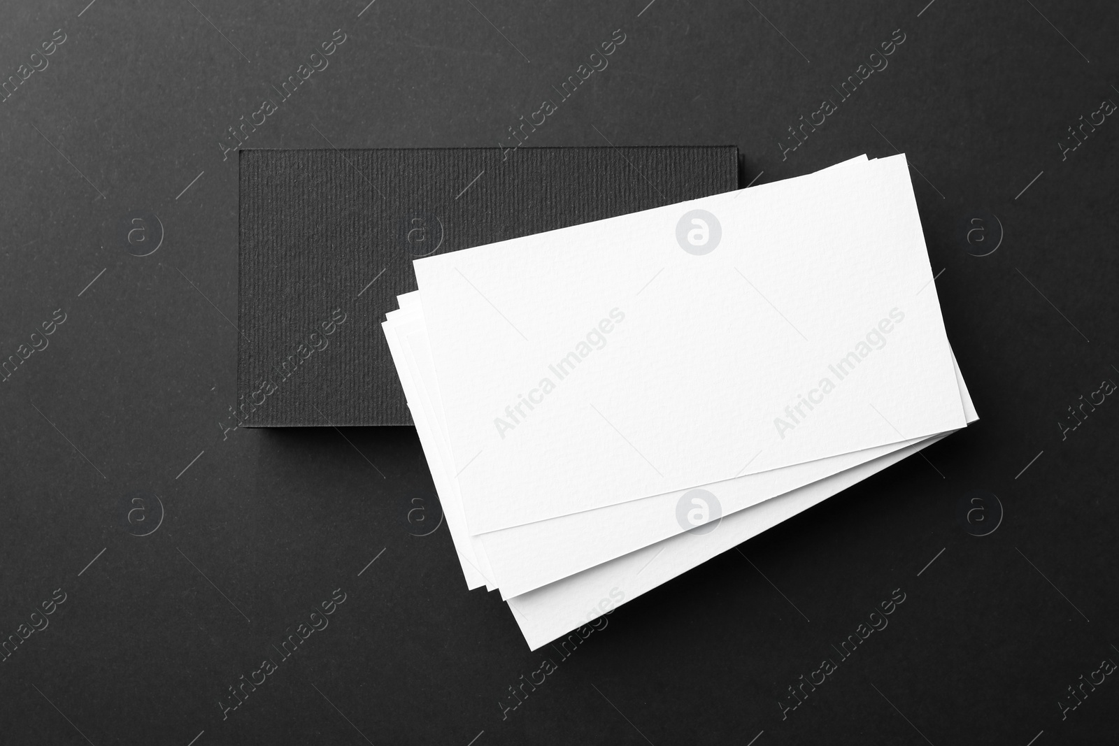 Photo of Blank business cards on black background, top view. Mockup for design