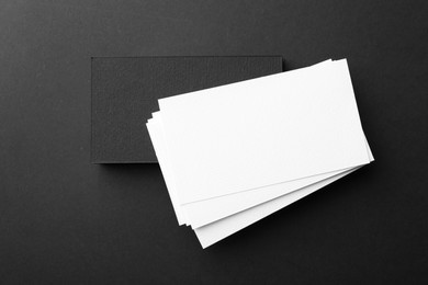 Blank business cards on black background, top view. Mockup for design