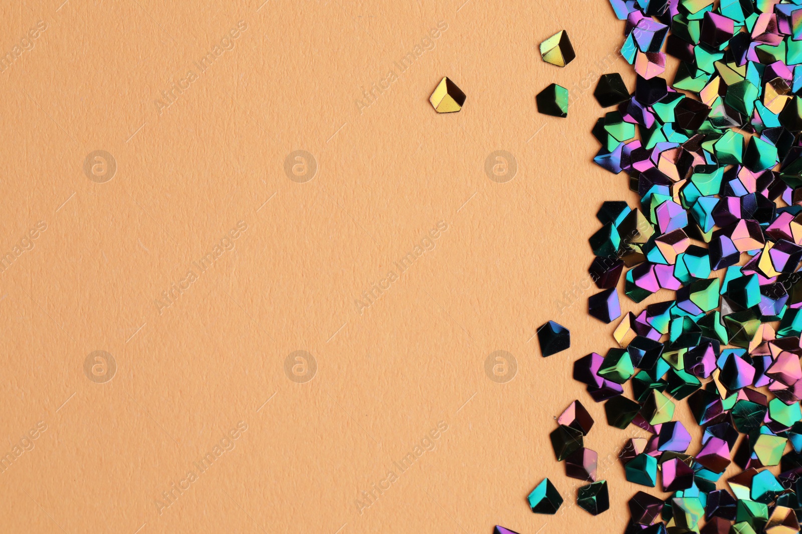 Photo of Pile of shiny glitter on beige background, flat lay. Space for text