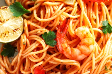 Photo of Delicious pasta with shrimps, closeup