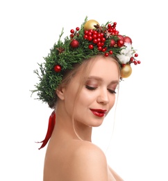 Beautiful young woman wearing Christmas wreath on white background