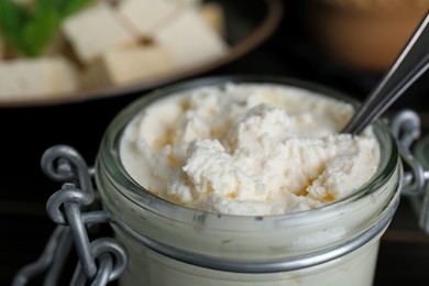 Photo of Delicious tofu cream cheese in glass jar, closeup