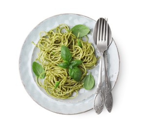 Photo of Delicious pasta with pesto sauce, basil and cutlery on white background, top view