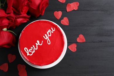 Photo of Bento cake with text Love You, roses, paper hearts and space for text on black wooden table, flat lay. St. Valentine's day surprise