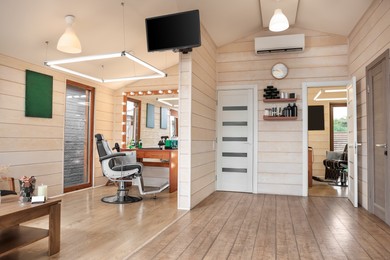 Photo of Stylish barbershop interior with professional hairdresser's workplace