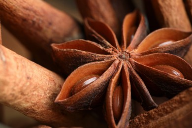 Photo of Aromatic cinnamon sticks and anise star as background, closeup
