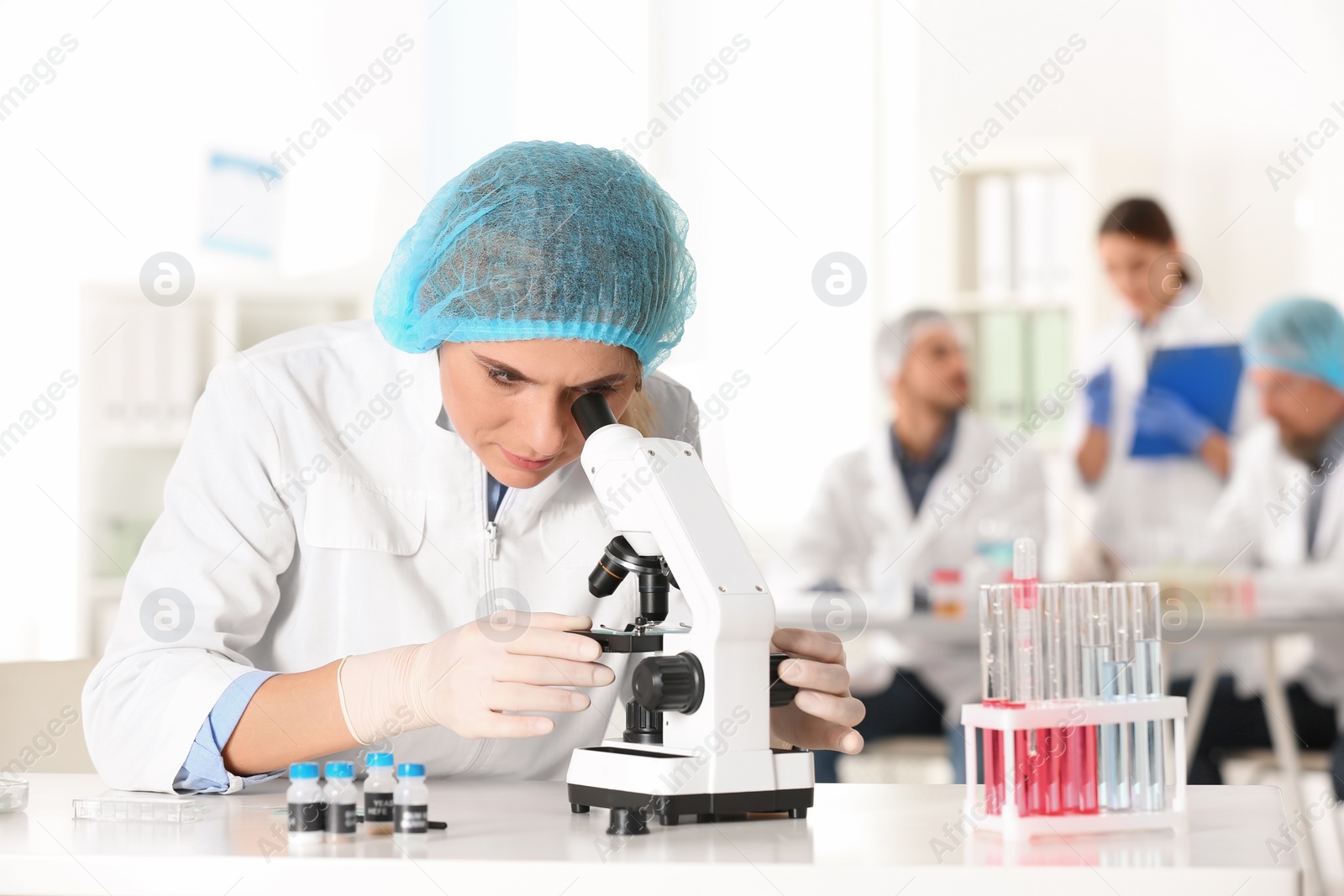 Photo of Female scientist working at table in laboratory, space for text. Research and analysis