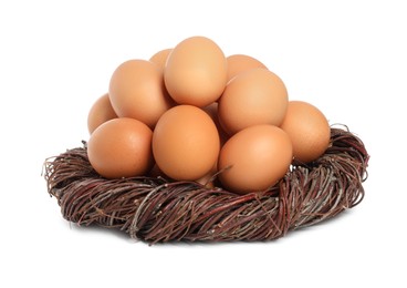 Photo of Chicken eggs and nest isolated on white