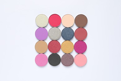 Different beautiful eye shadows on white background, flat lay