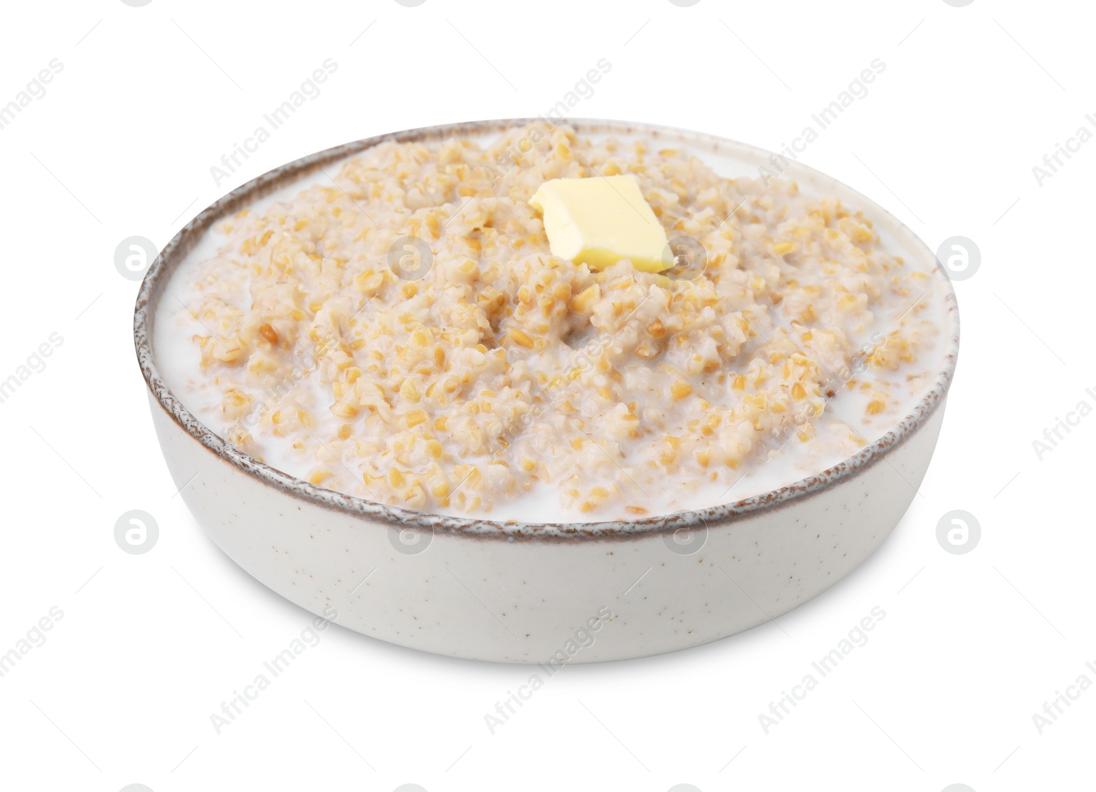 Photo of Tasty wheat porridge with milk and butter in bowl isolated on white