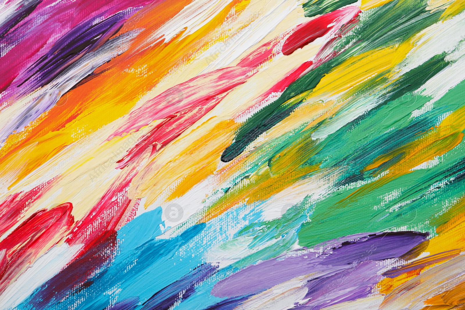 Photo of Beautiful strokes of colorful oil paints on white canvas as background, closeup