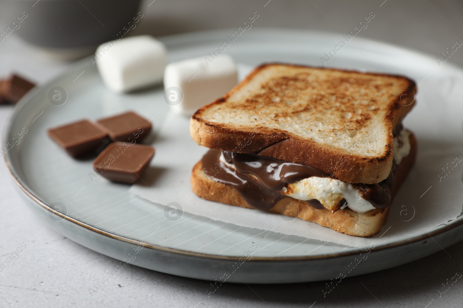 Photo of Delicious marshmallow sandwiches with bread and chocolate on wooden table, closeup