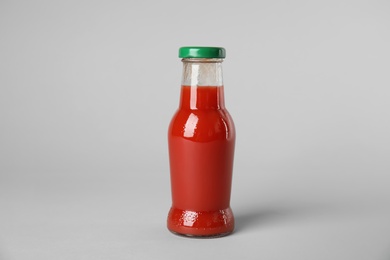 Photo of One bottle with tasty drink on color background