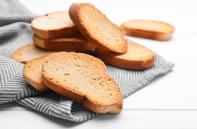 Photo of Tasty hard chuck crackers on white wooden table