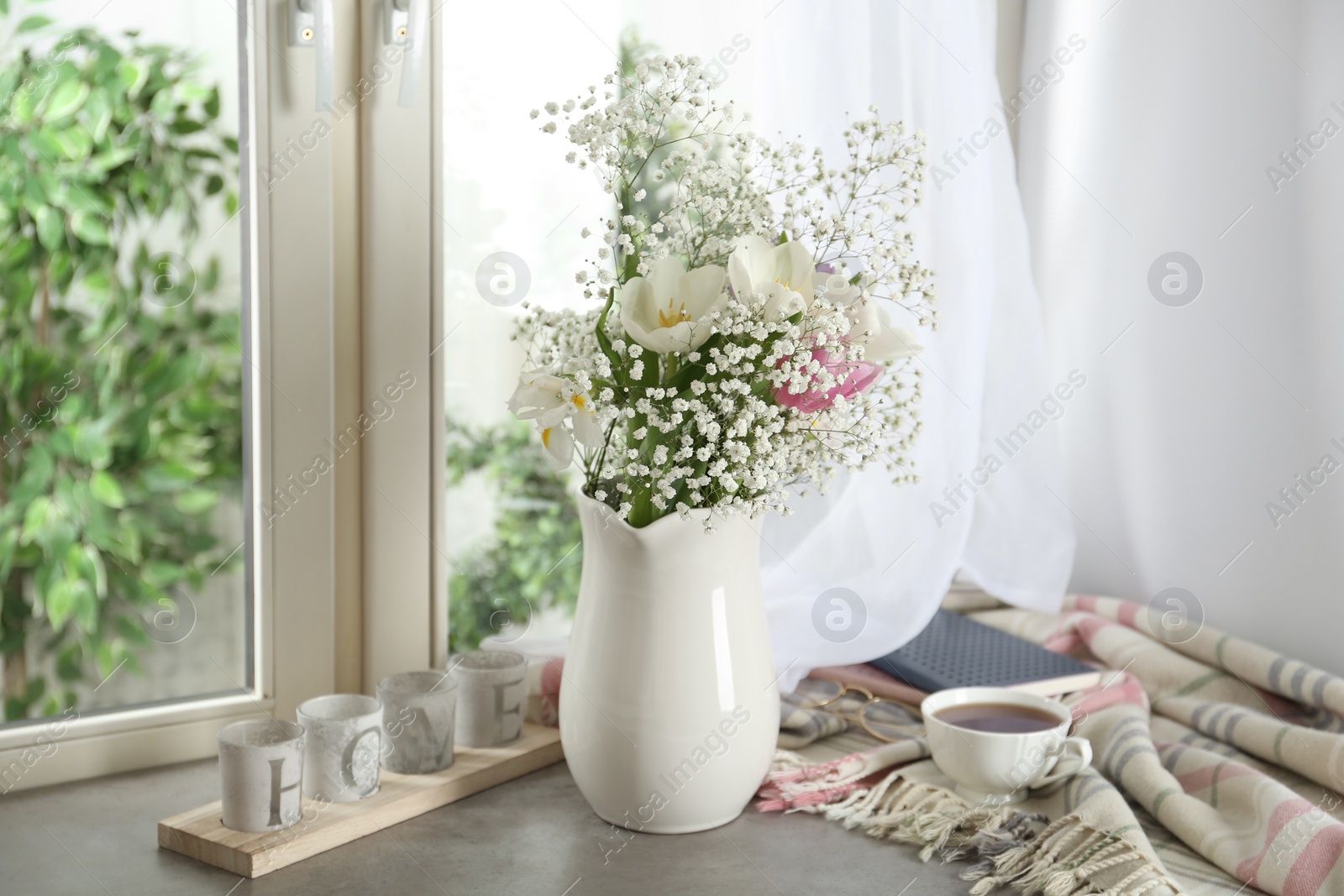 Photo of Beautiful fresh flowers on window sill indoors