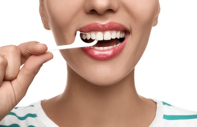 Young woman flossing her teeth on white background, closeup. Cosmetic dentistry