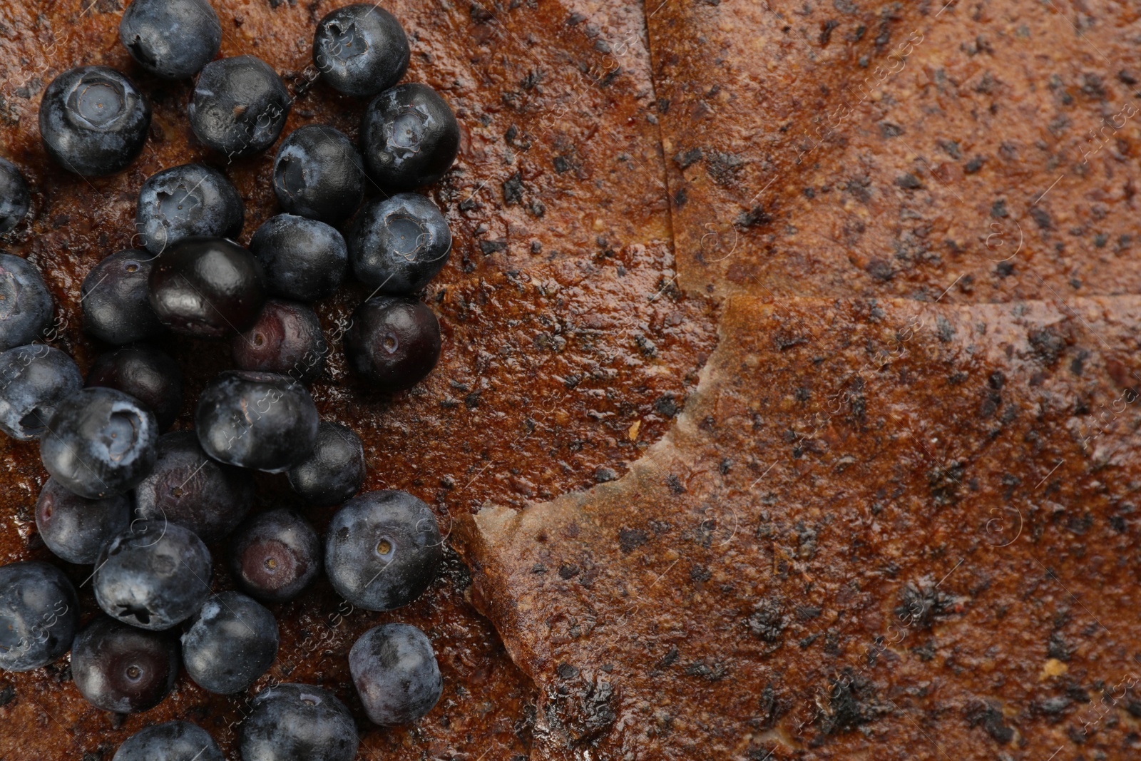 Photo of Blueberries on delicious fruit leather, flat lay. Space for text