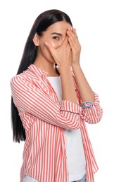 Embarrassed young woman covering face with hands on white background