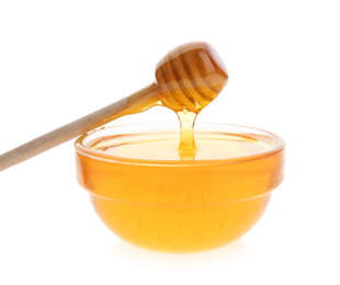Photo of Honey dripping from dipper into bowl on white background