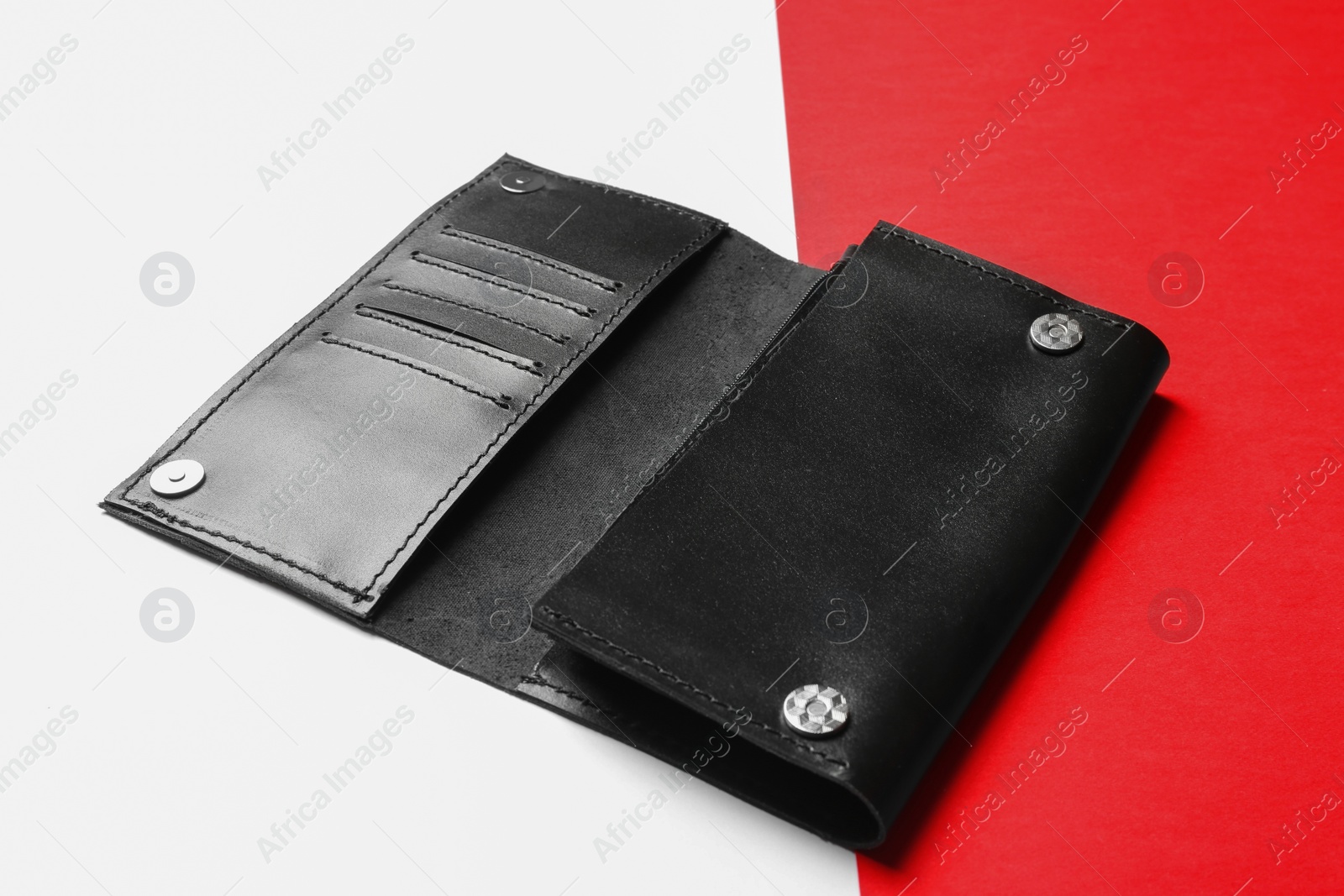 Photo of Black leather wallet on color background. Stylish accessory