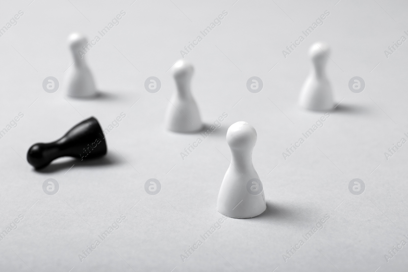 Photo of One pawn standing out from others on table. Be different