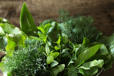 Photo of Closeup view of different herbs on wooden background