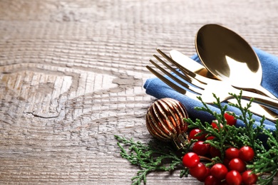 Cutlery set on wooden table, closeup view with space for text. Christmas celebration