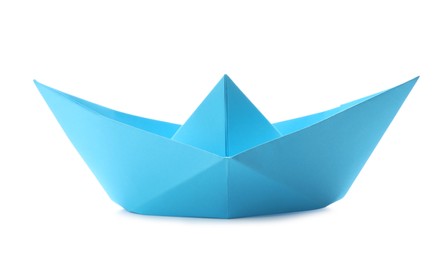 Photo of Handmade light blue paper boat isolated on white. Origami art