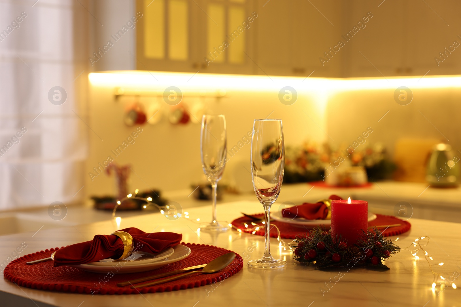 Photo of Christmas table setting with festive decor in kitchen