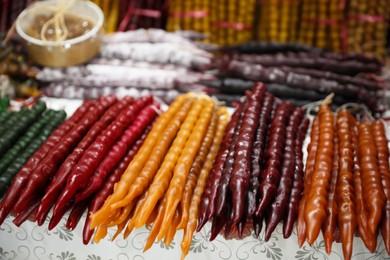 Different delicious sweet churchkhelas on counter at market