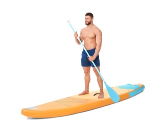 Photo of Happy man with paddle on orange SUP board against white background