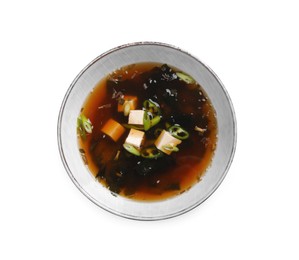 Photo of Bowl of delicious miso soup with tofu isolated on white, top view