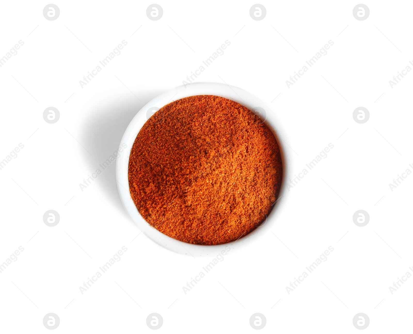 Photo of Bowl of ground pepper isolated on white, top view